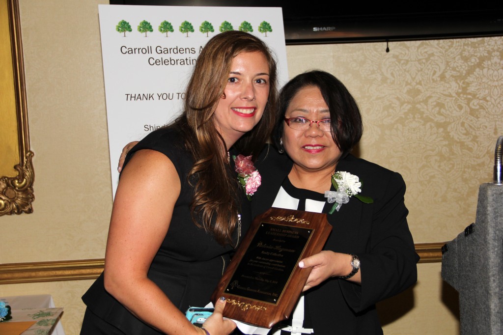 Victoria Hagman, Owner of Realty Collective, accepts the Small Business Leadership Award from CGA Executive Director Vilma Heramia.
